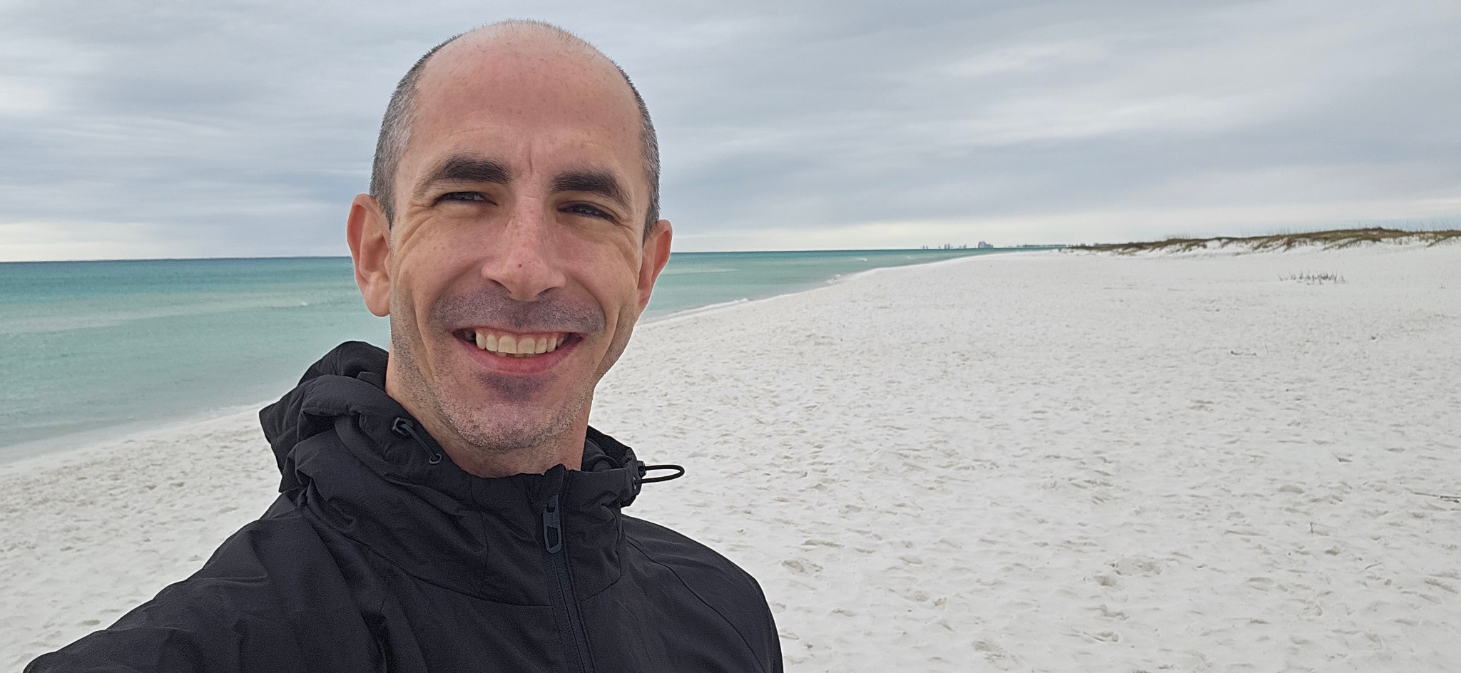 Gary Griggers smiling on a beach